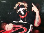 Violent J signs a poster